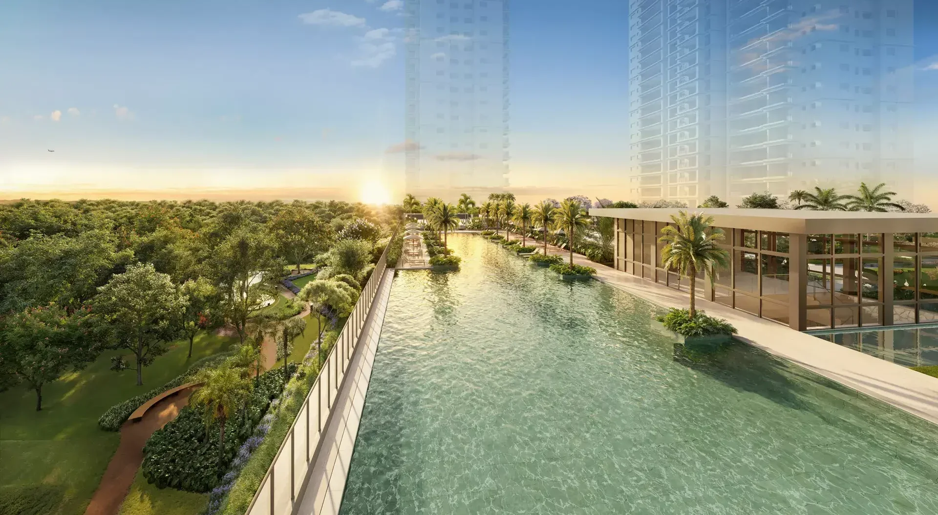 Piscina descoberta com raia de 60 metros do Jardim da Hípica ao pôr do sol, com a praça arborizada à esquerda